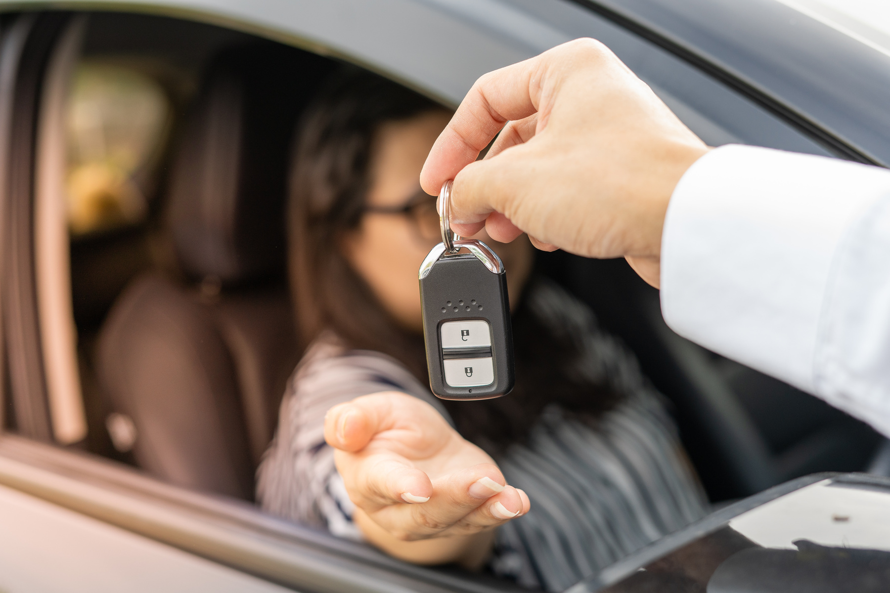 An employee of a tourist car rental company presents the car