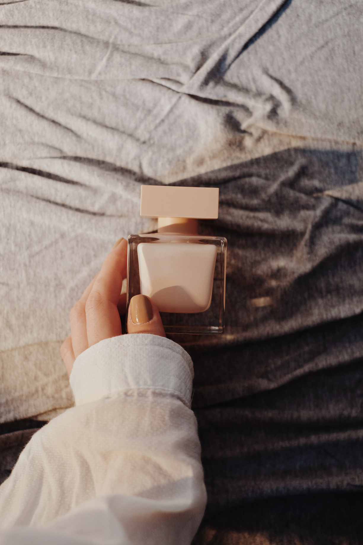 Woman touching bottle of nail polish